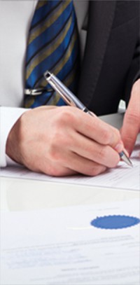 et-img Signing a document. McCanliss & Early estates & trusts practice.