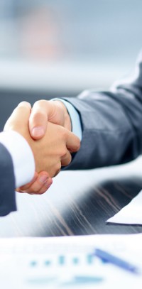 Businessmen shaking hands. McCanliss & Early securities arbitration practice.